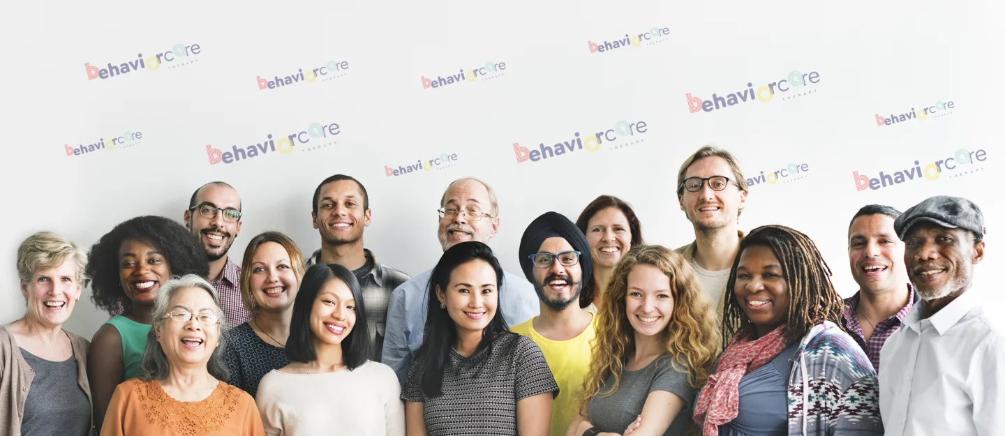Smiling people standing in front of panel with behaviorcare logos